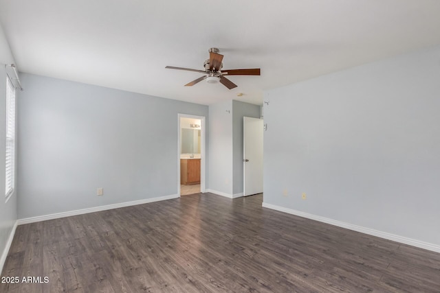 spare room featuring ceiling fan, a healthy amount of sunlight, and dark wood-type flooring