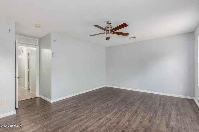 spare room with dark hardwood / wood-style floors and ceiling fan