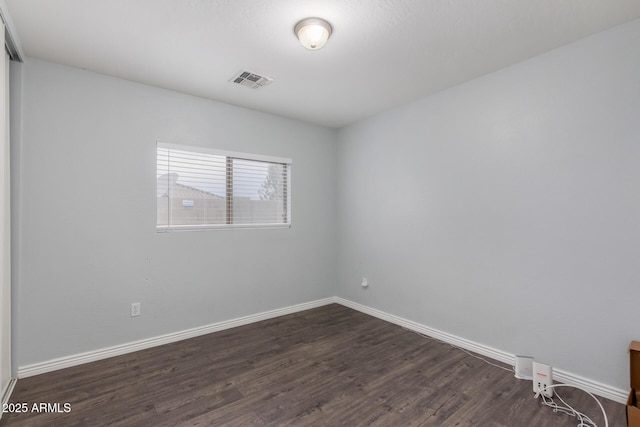 spare room with dark wood-type flooring