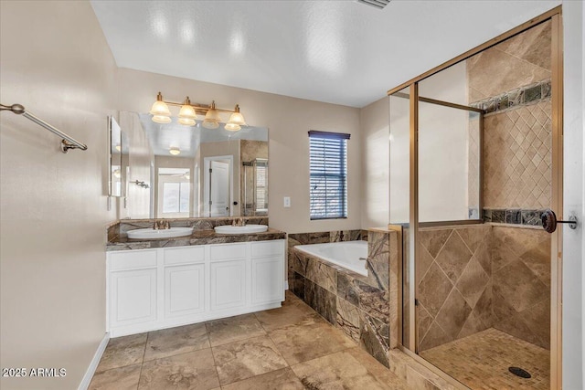 bathroom with vanity and independent shower and bath