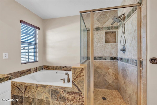 bathroom featuring shower with separate bathtub