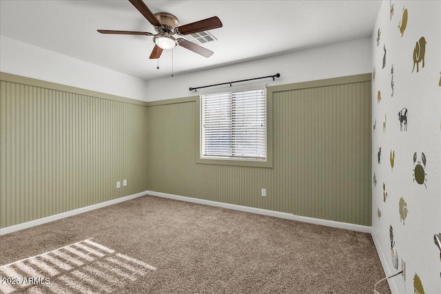 carpeted spare room with ceiling fan