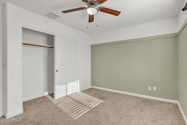 unfurnished bedroom with carpet, ceiling fan, and a closet