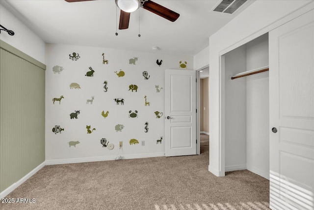 unfurnished bedroom with ceiling fan, a closet, and light carpet