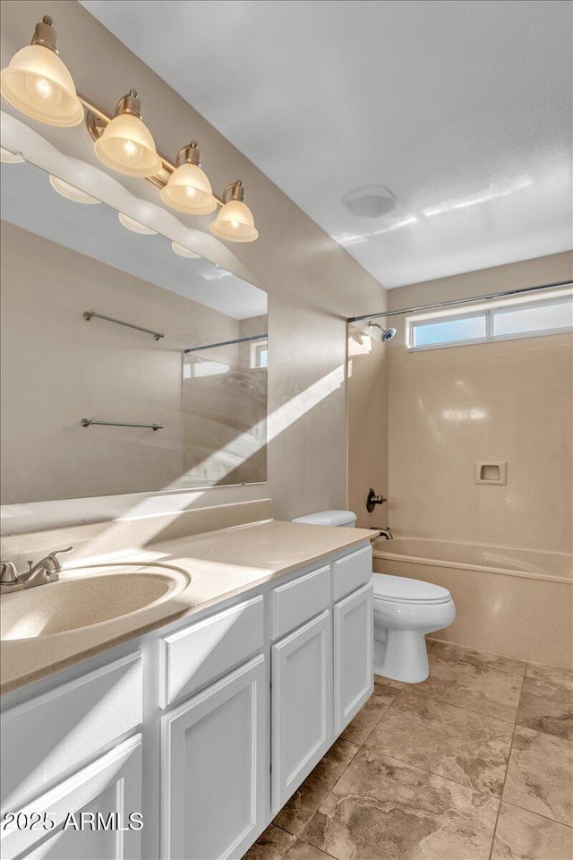 full bathroom with vanity, bathtub / shower combination, and toilet