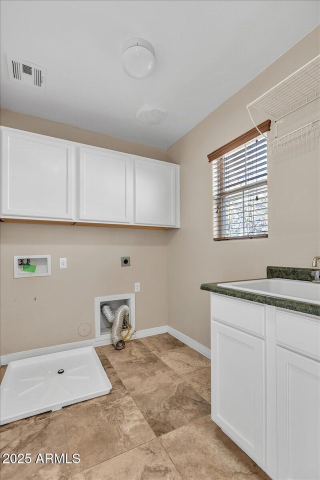 clothes washing area featuring hookup for a washing machine, sink, hookup for an electric dryer, and cabinets