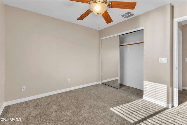 unfurnished bedroom featuring ceiling fan, carpet floors, and a closet