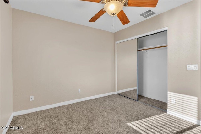 unfurnished bedroom with carpet floors, ceiling fan, and a closet