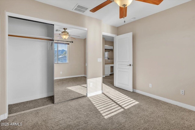 unfurnished bedroom featuring ceiling fan, carpet flooring, and a closet