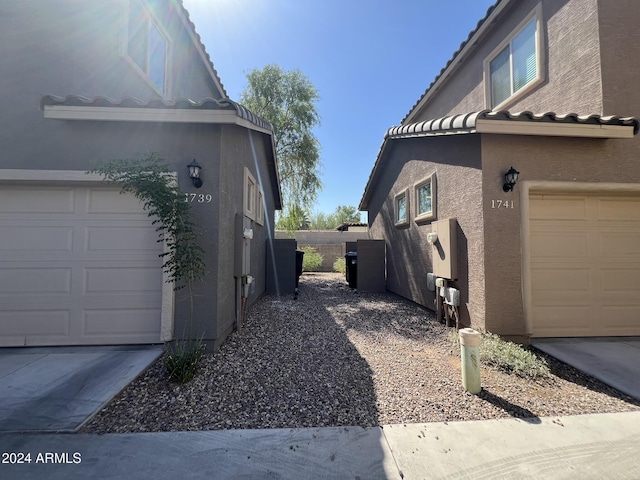 view of side of home featuring a garage