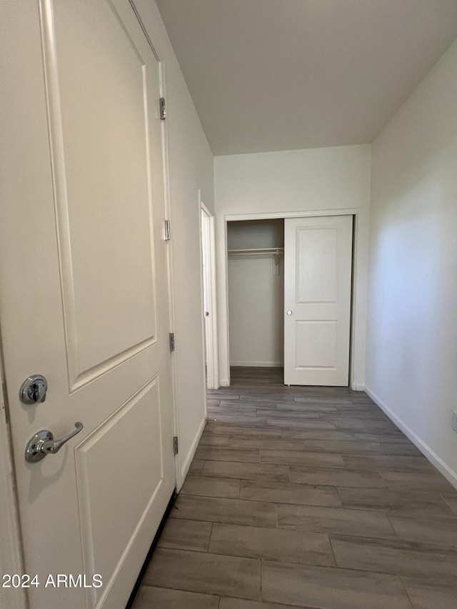 corridor with dark hardwood / wood-style floors