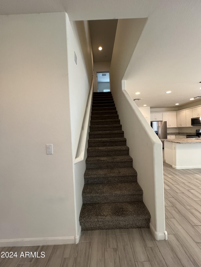 stairway featuring hardwood / wood-style floors