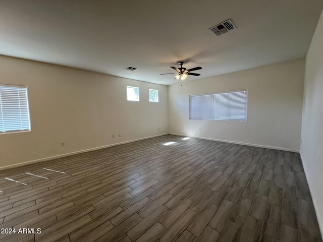 unfurnished room featuring ceiling fan and dark hardwood / wood-style floors