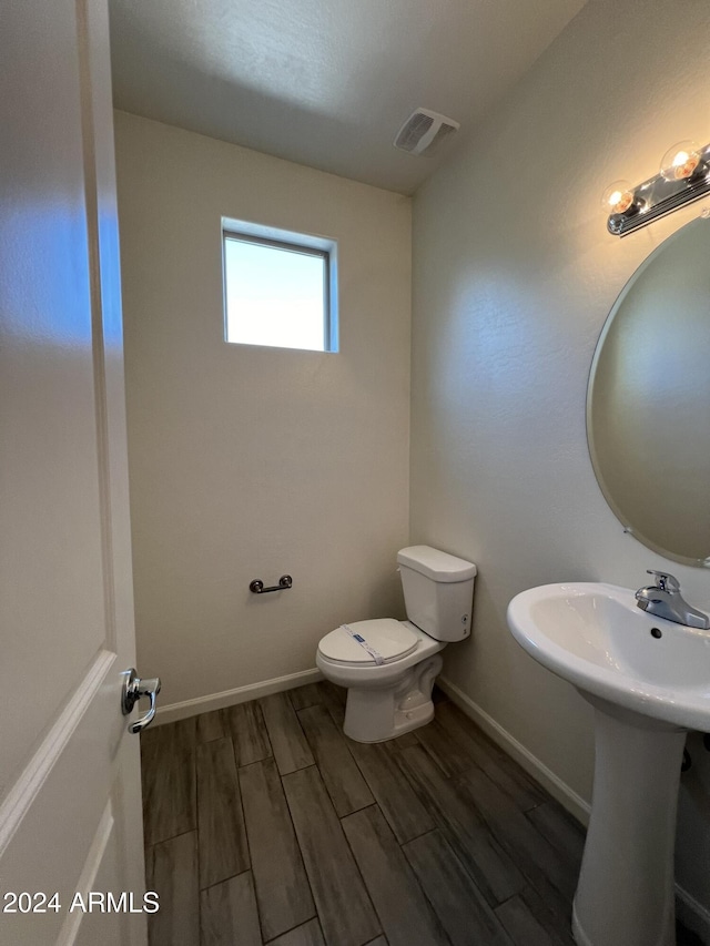 bathroom featuring toilet and hardwood / wood-style flooring