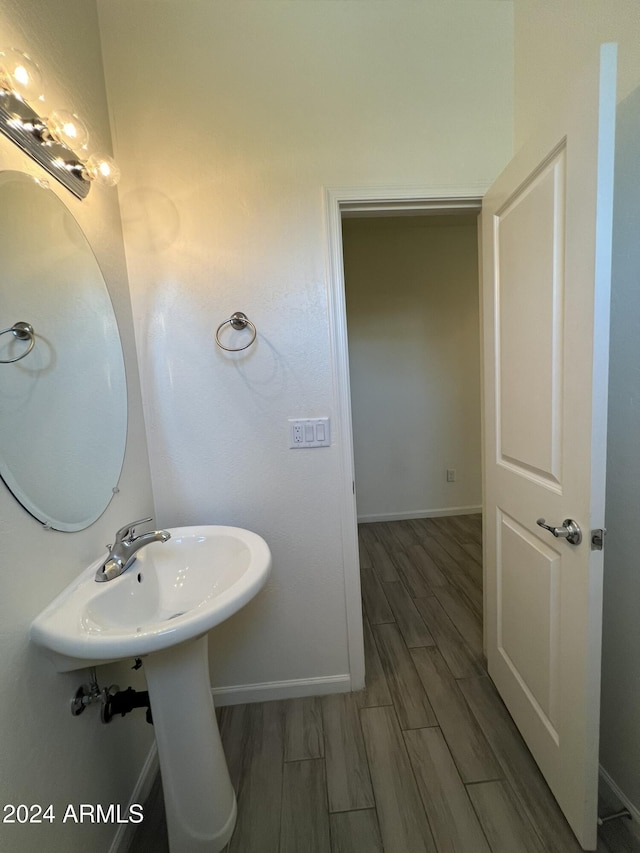 bathroom with hardwood / wood-style floors