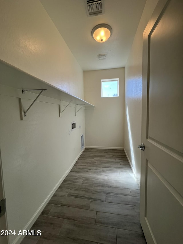 washroom with hardwood / wood-style flooring and hookup for a washing machine