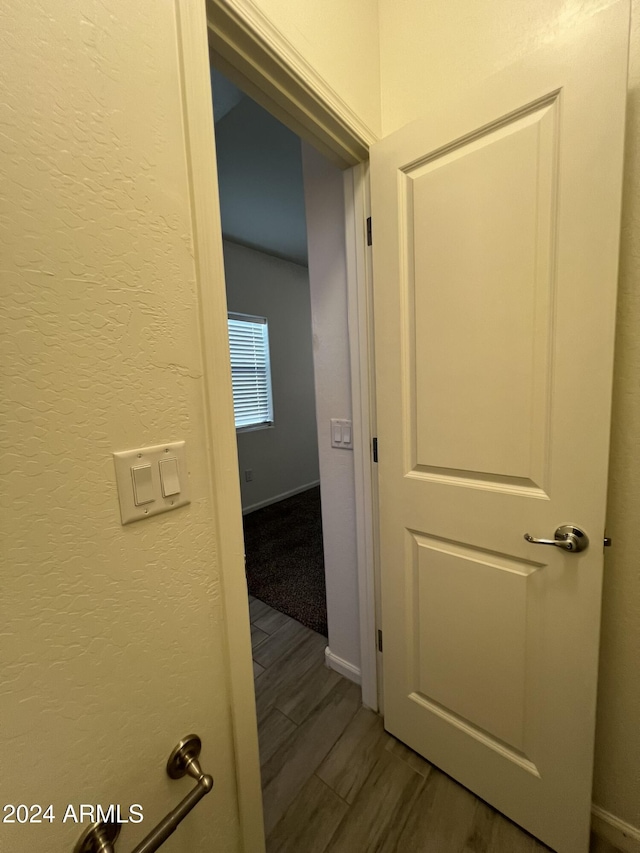 corridor featuring wood-type flooring