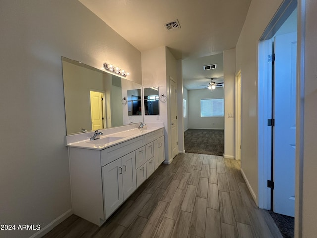 bathroom featuring ceiling fan, hardwood / wood-style floors, and vanity