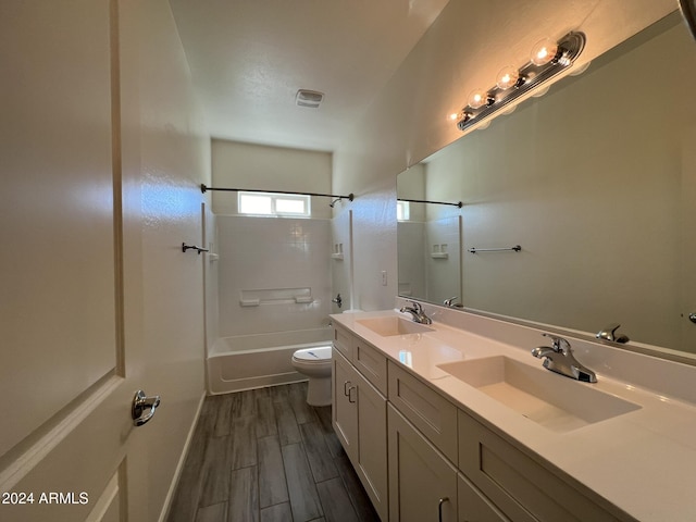 full bathroom featuring vanity, toilet, wood-type flooring, and bathing tub / shower combination