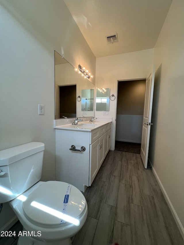 bathroom featuring hardwood / wood-style floors, vanity, and toilet