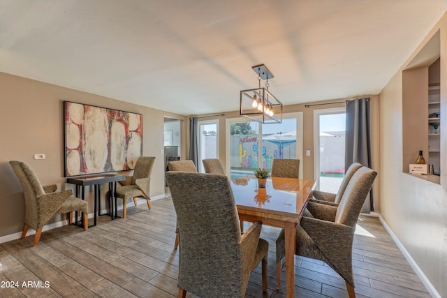 dining space featuring baseboards and wood finished floors