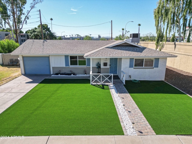single story home with brick siding, roof with shingles, concrete driveway, a garage, and a front lawn