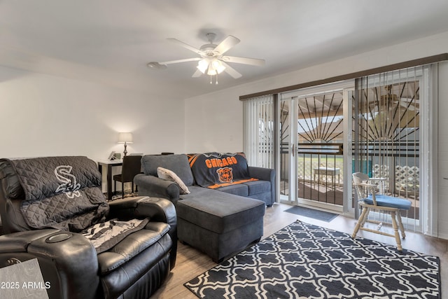 living room with wood finished floors and a ceiling fan