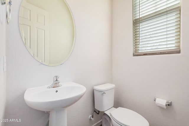 bathroom featuring toilet and a sink