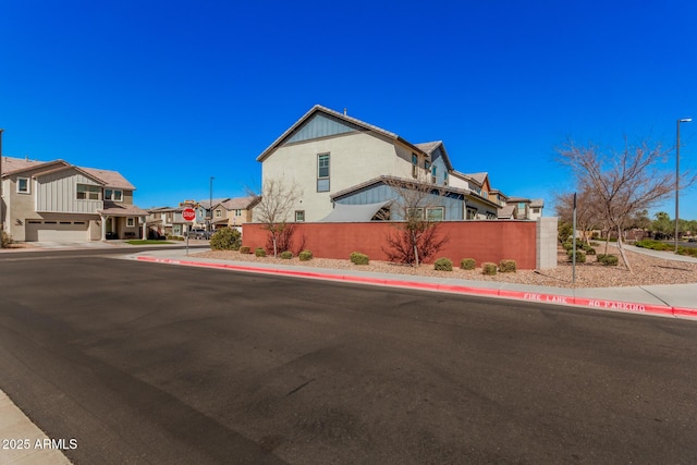 view of side of property with a residential view and fence