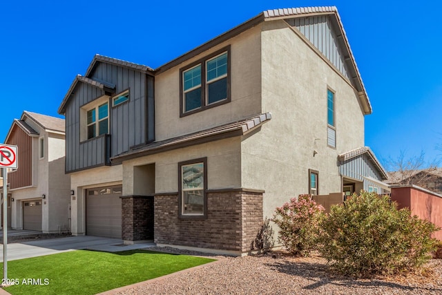 view of front facade featuring an attached garage, brick siding, concrete driveway, stucco siding, and board and batten siding