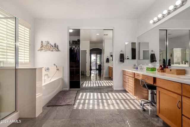 bathroom with plenty of natural light, vanity, and shower with separate bathtub