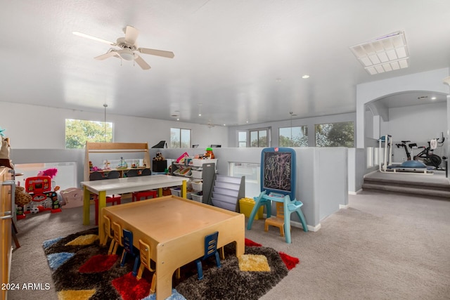 game room with light colored carpet, plenty of natural light, and ceiling fan