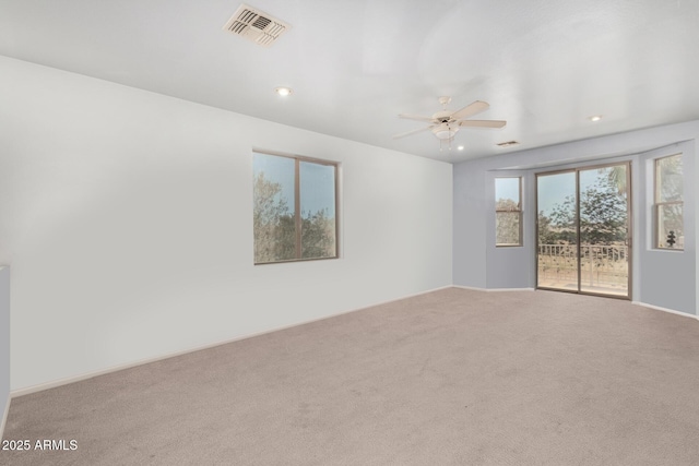 spare room with ceiling fan and carpet floors