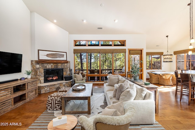 living room featuring recessed lighting, a high ceiling, a fireplace, wood finished floors, and visible vents