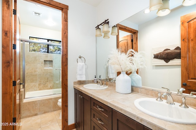 bathroom with tile patterned flooring, visible vents, a sink, and double vanity