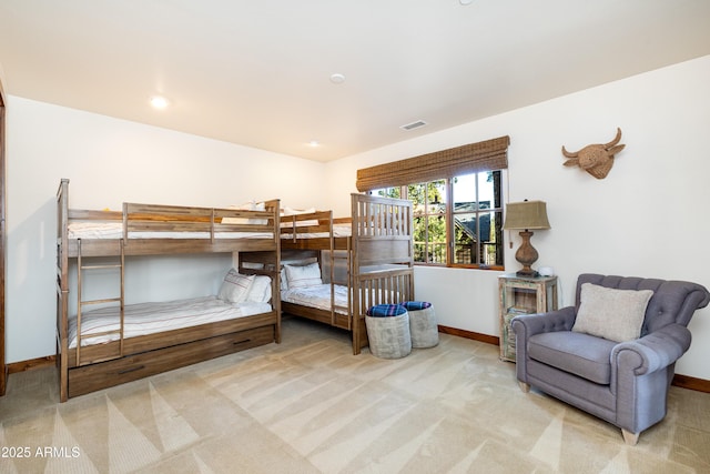 carpeted bedroom featuring visible vents and baseboards