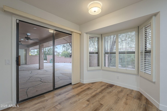 interior space with hardwood / wood-style flooring and ceiling fan