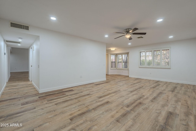 empty room featuring ceiling fan and light wood-type flooring