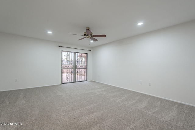 unfurnished room with ceiling fan and light colored carpet