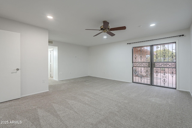 unfurnished room featuring light colored carpet and ceiling fan