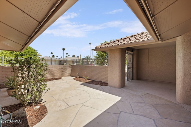 view of patio / terrace featuring fence