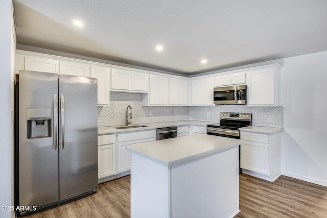 3801 E Captain Dreyfus Ave, Phoenix, AZ 85032 - kitchen with stainless steel appliances, tasteful backsplash, light countertops, white cabinets, and light wood-style floors