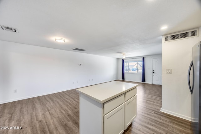 3801 E Captain Dreyfus Ave, Phoenix, AZ 85032 - kitchen with open floor plan, freestanding refrigerator, a ceiling fan, wood finished floors, and light countertops