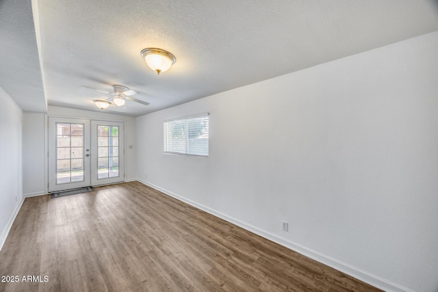3801 E Captain Dreyfus Ave, Phoenix, AZ 85032 - unfurnished room with ceiling fan, wood finished floors, french doors, and a textured ceiling