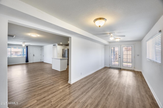 3801 E Captain Dreyfus Ave, Phoenix, AZ 85032 - unfurnished living room with ceiling fan, wood finished floors, french doors, and a textured ceiling