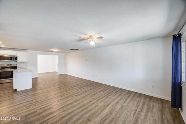 3801 E Captain Dreyfus Ave, Phoenix, AZ 85032 - unfurnished living room with wood finished floors, ceiling fan, and a textured ceiling