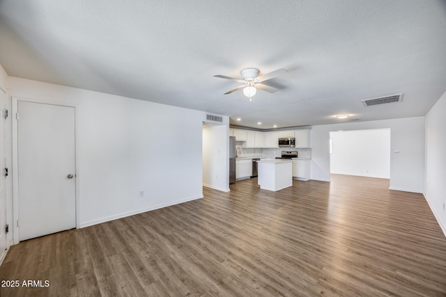 3801 E Captain Dreyfus Ave, Phoenix, AZ 85032 - unfurnished living room with a ceiling fan, wood finished floors, and recessed lighting