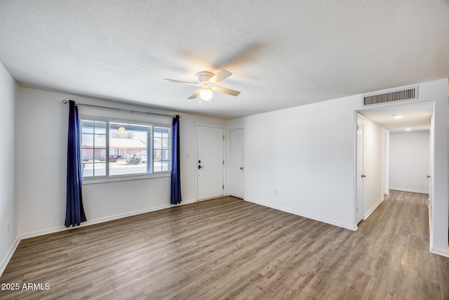 3801 E Captain Dreyfus Ave, Phoenix, AZ 85032 - unfurnished room with a ceiling fan, wood finished floors, and a textured ceiling
