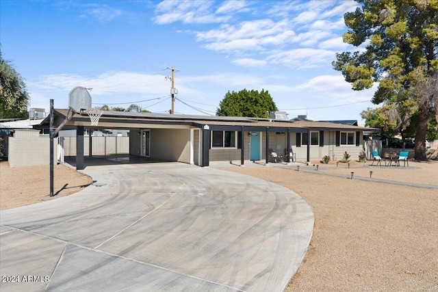 ranch-style home featuring a carport