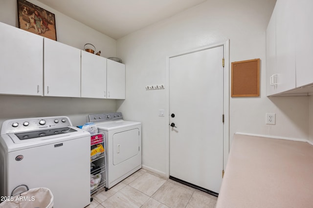 laundry area with cabinet space, washing machine and clothes dryer, and light tile patterned flooring